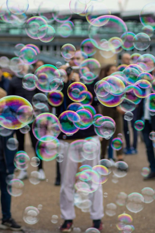 a bunch of bubbles are flying through the air