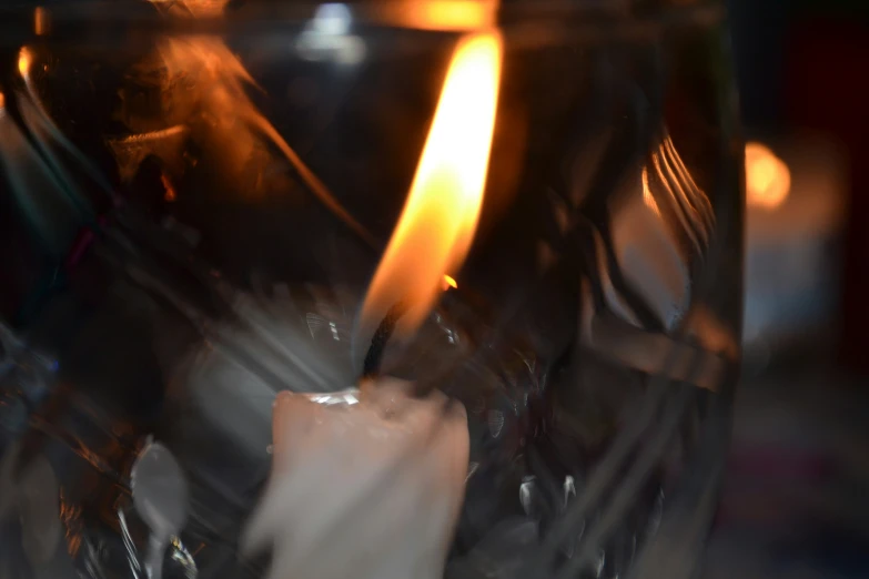 a candle is glowing inside of a glass