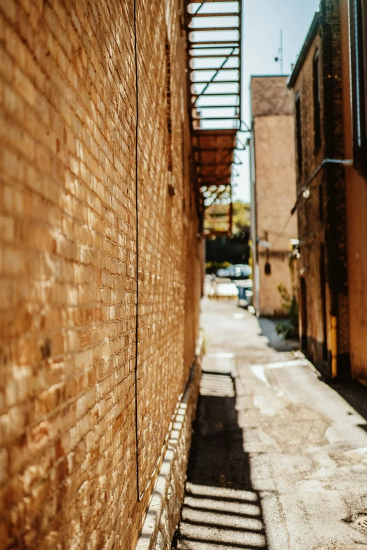 an alleyway that has a brick wall in it