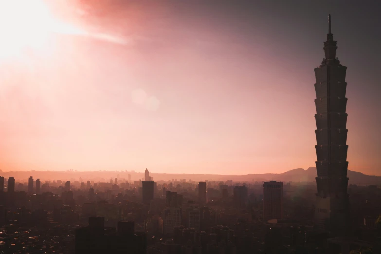 the sun setting over the city, and the skyline