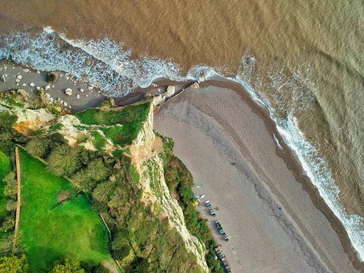 aerial view of an open beach with surf