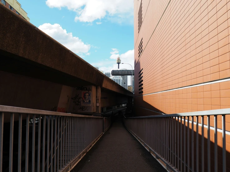 a fence surrounding the side of an orange brick building