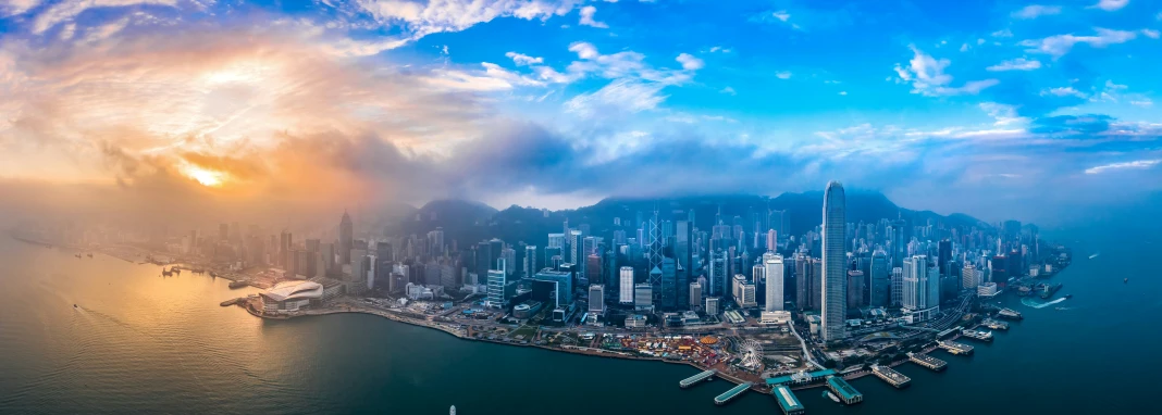 a large city sitting next to the ocean under a blue sky