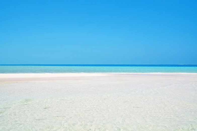 beach on clear and blue day with only some footprints