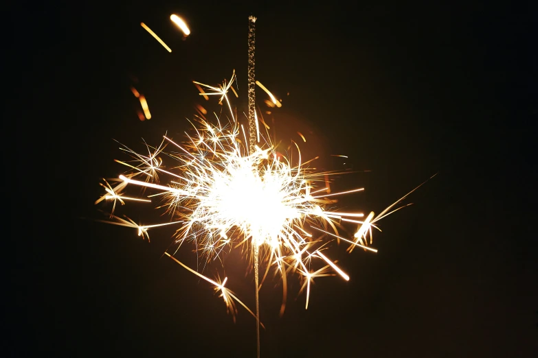 a large white firework on top of a black background