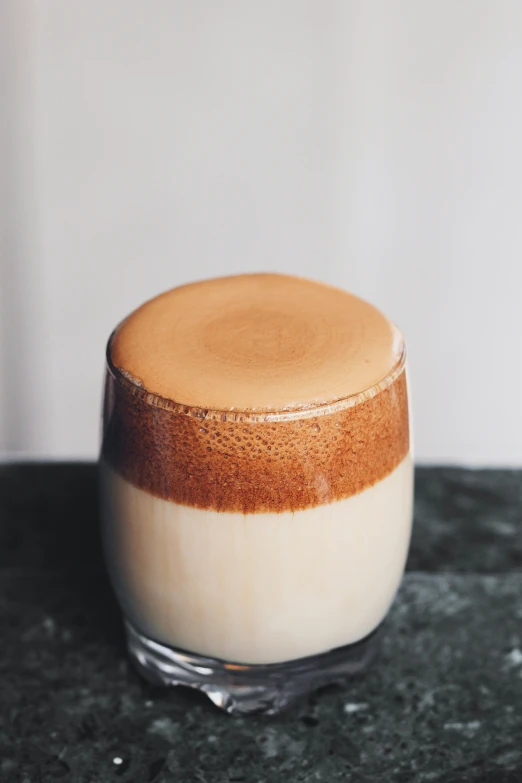 a cup sitting on top of a black counter