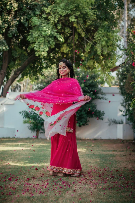 woman wearing traditional sari posing for a po in a park