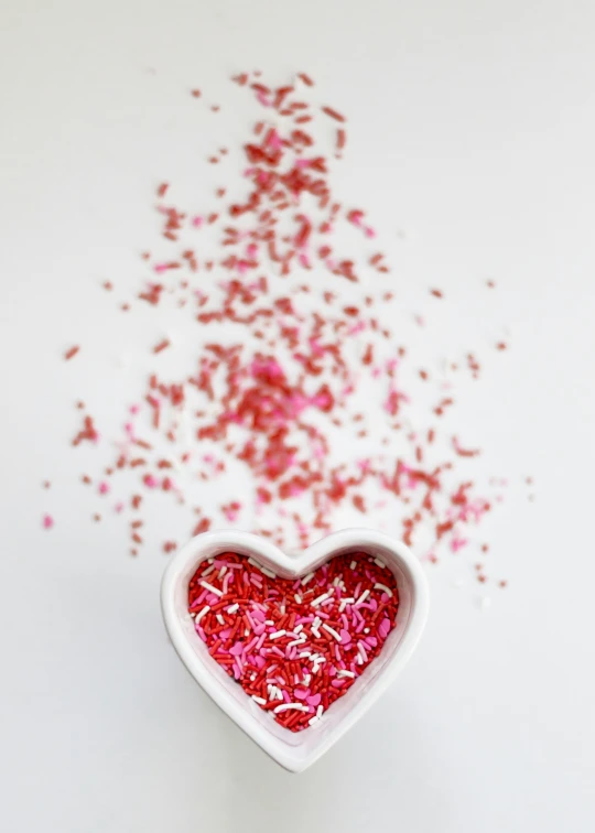 small heart shaped bowl of sprinkles with small sprinkles in the center