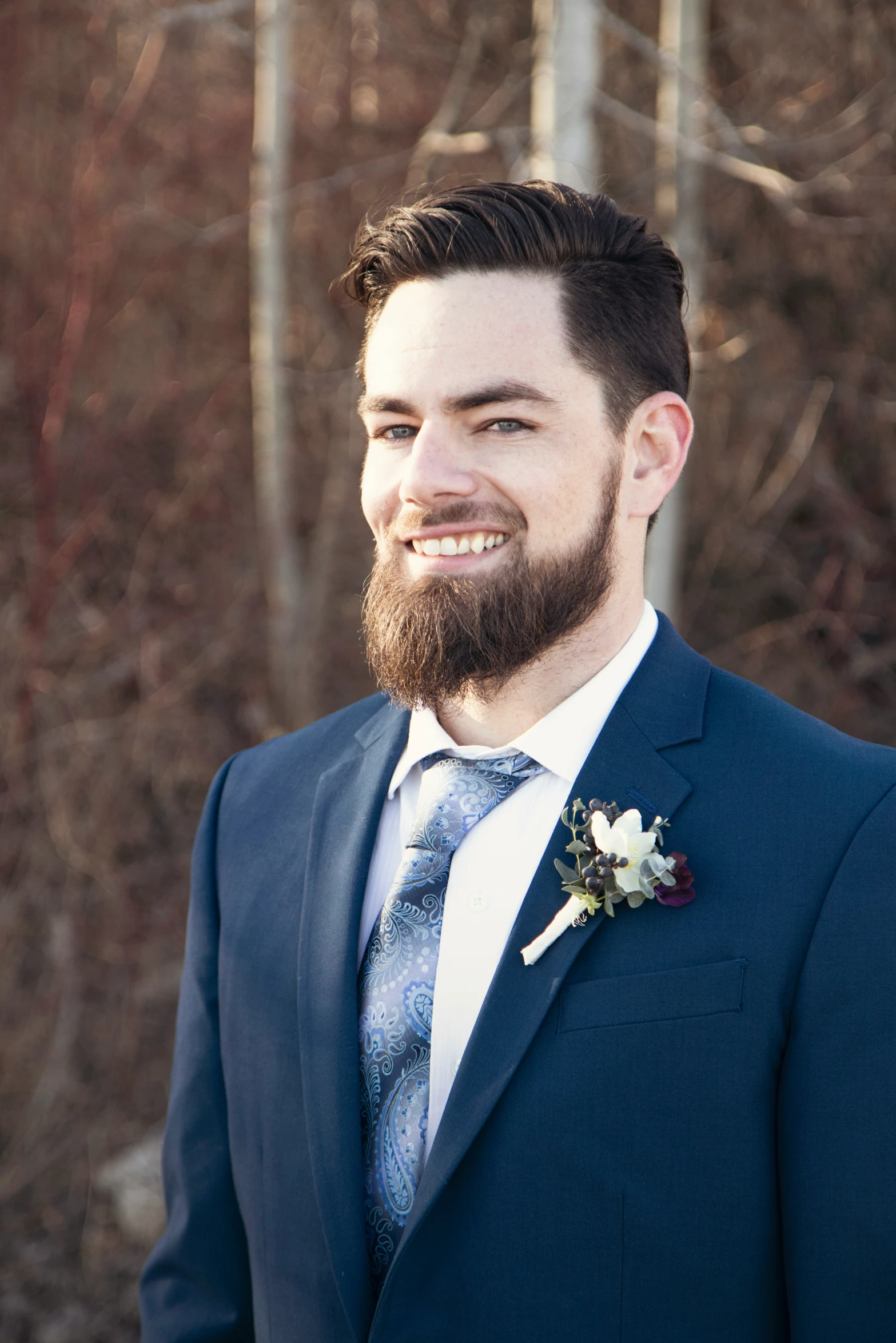 a man with a beard wearing a blue suit