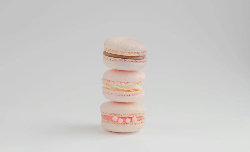 a stack of four macaroons made of various types of doughnuts