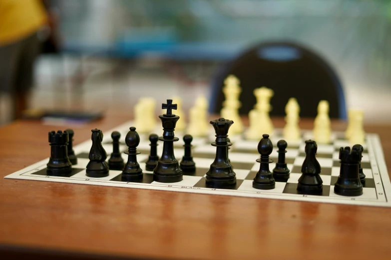 chess board with black and white pieces sitting on top of it