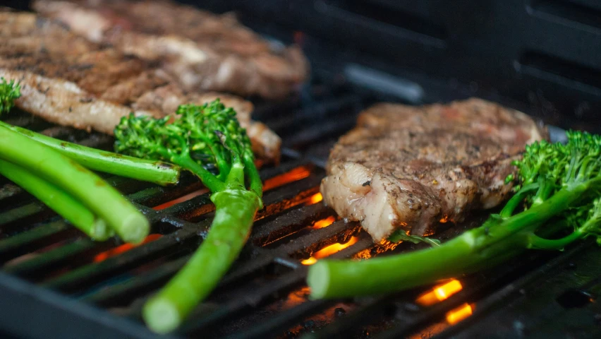 broccoli and steak sit on the grill