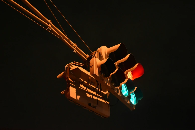 a street light with red and green traffic lights attached to a pole