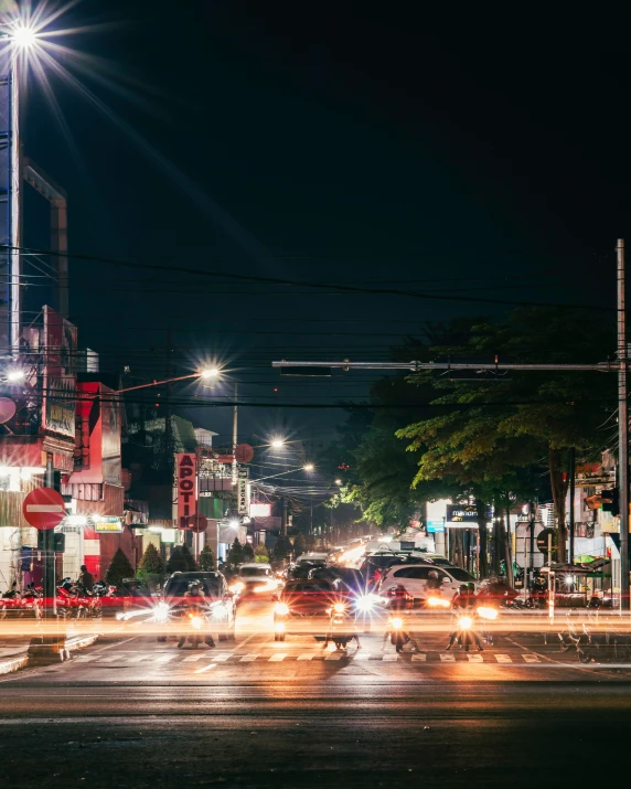 a city intersection with lots of cars at night