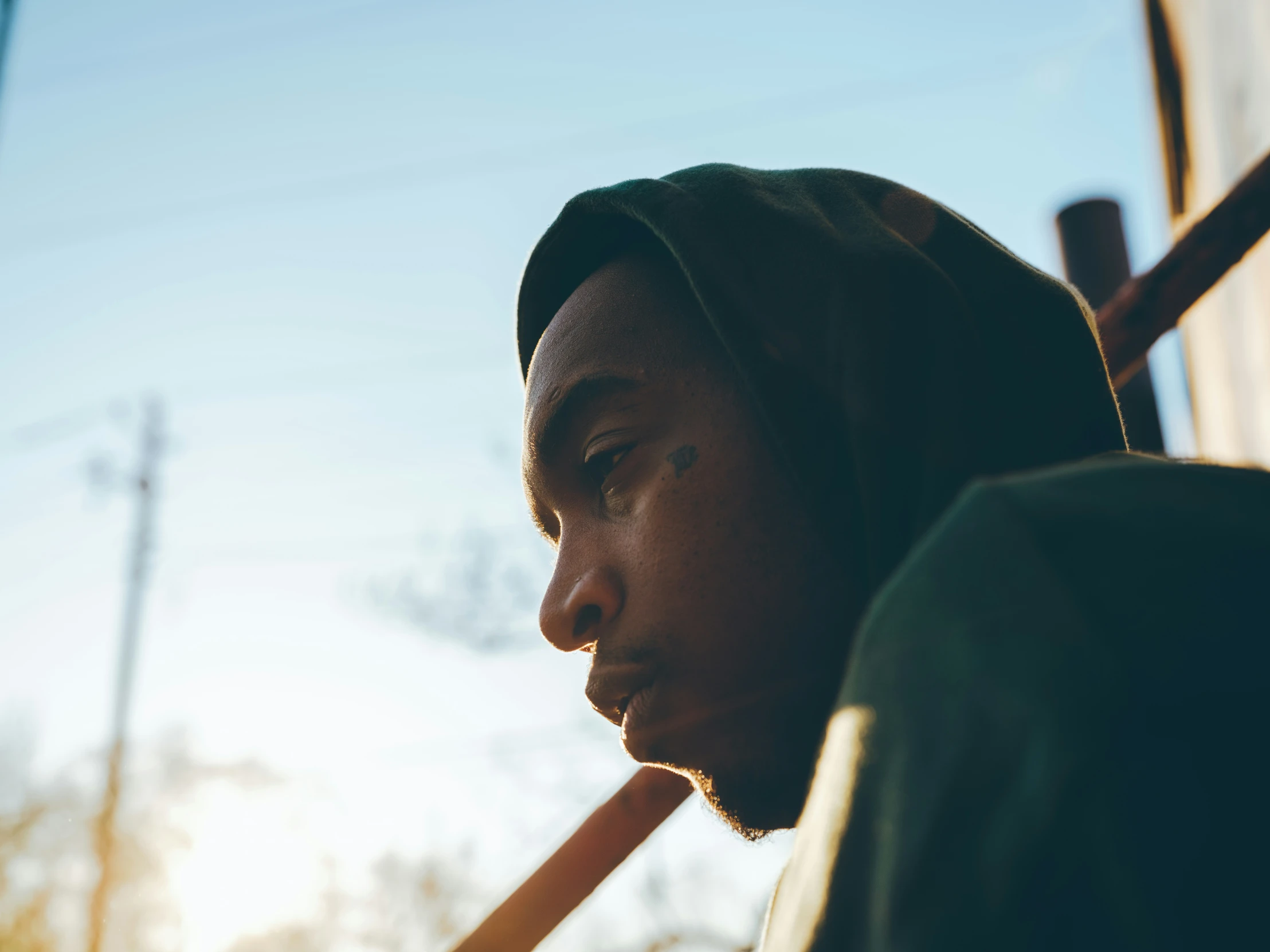 man wearing hoody with a pencil next to his mouth