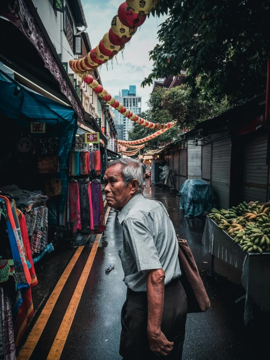 an older man walking down a dark street