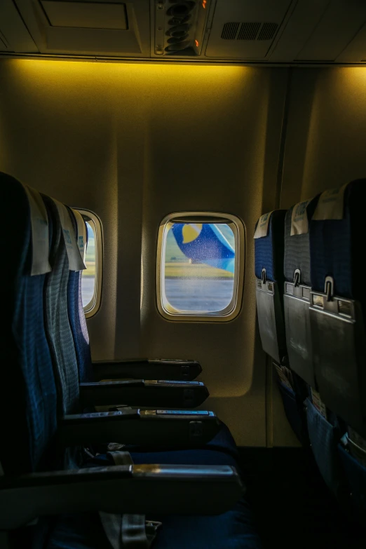 the view from inside a commercial airline airplane at the far end, looking out of windows and showing a full ocean scene