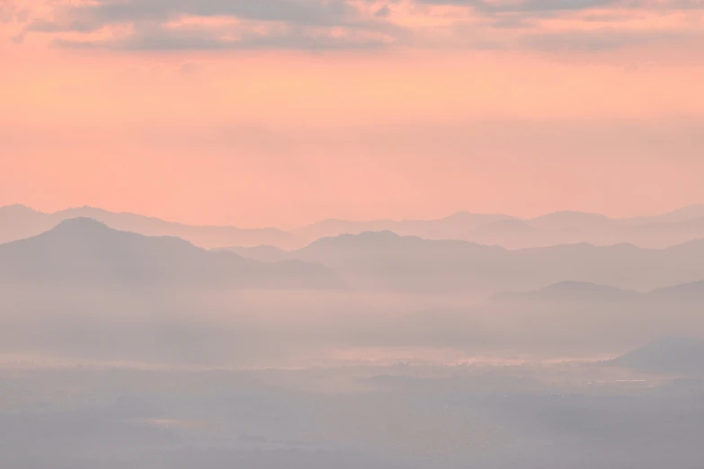 a lone airplane with mountains in the distance