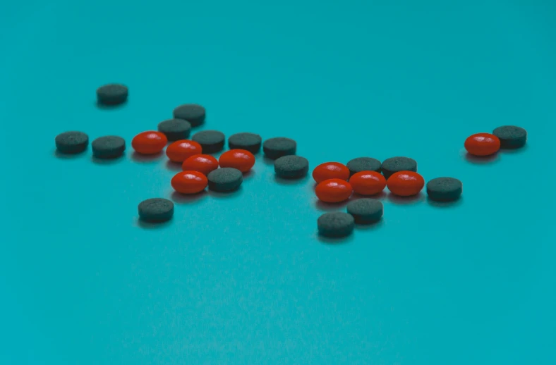 a group of red and black pills are shown