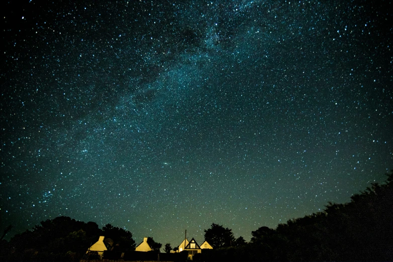 a row of houses under a cluster of stars