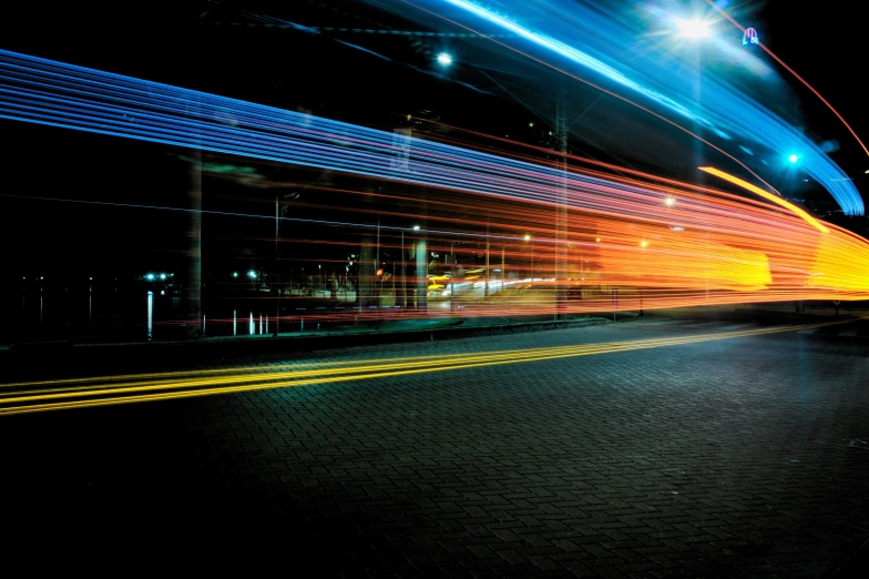 a night scene with lights in motion on a dark background