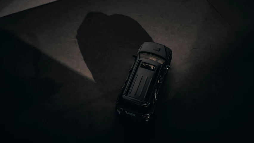 a shadow from a car on a black floor