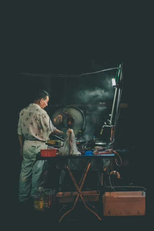 two people standing around a large, old metal object