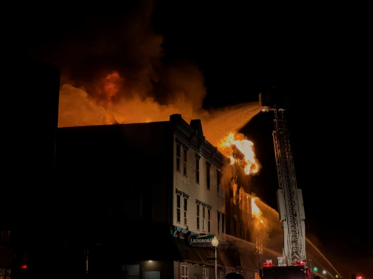 a fire is raging in the distance behind some buildings