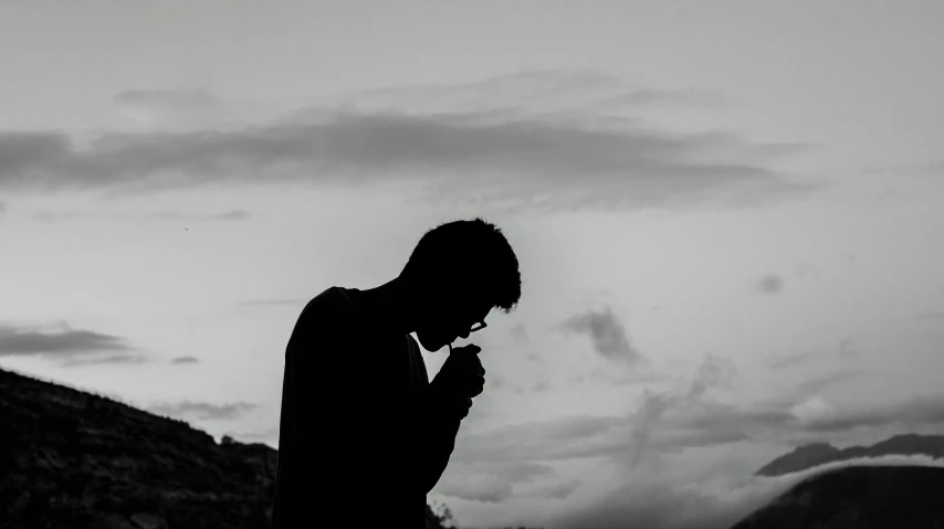 a person on a cell phone near mountains