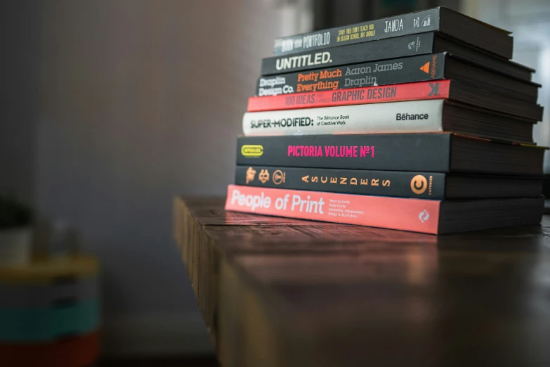 a stack of books sitting on top of a table