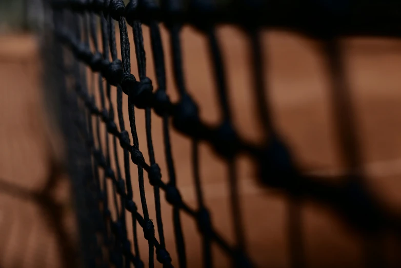 the edge of a tennis net is seen from below