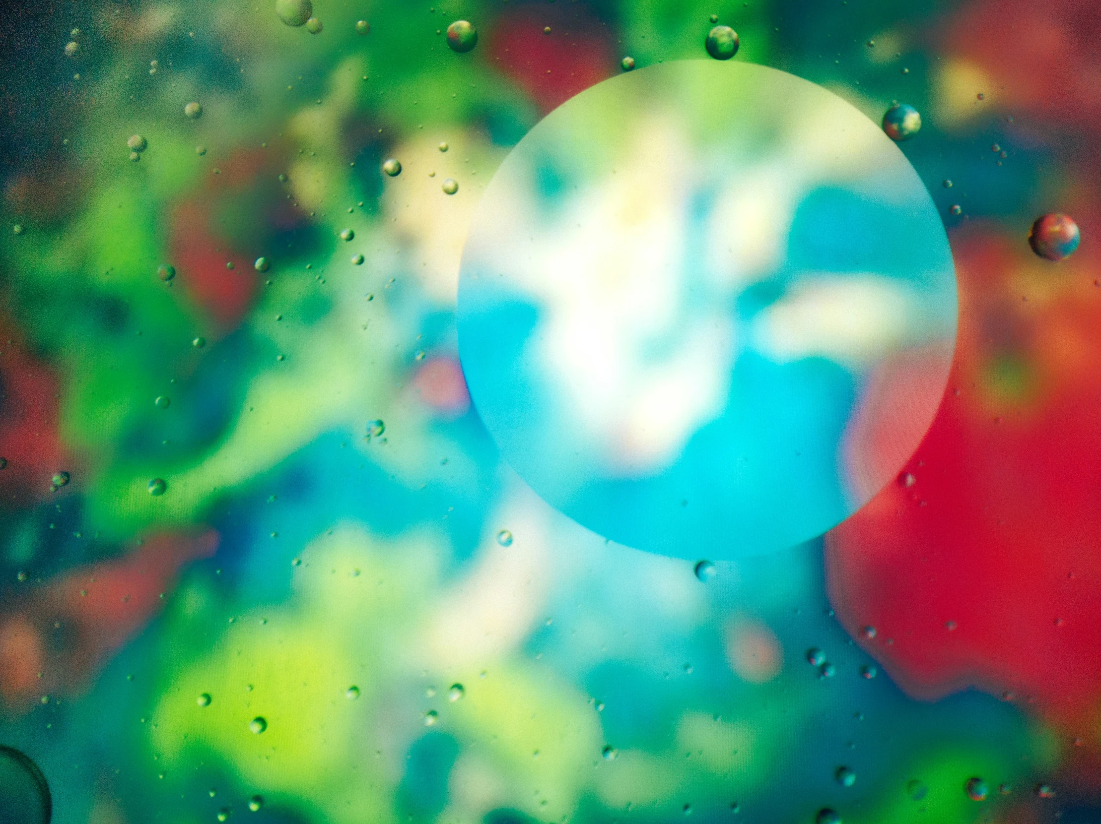 a picture of a green white blue and yellow bubble