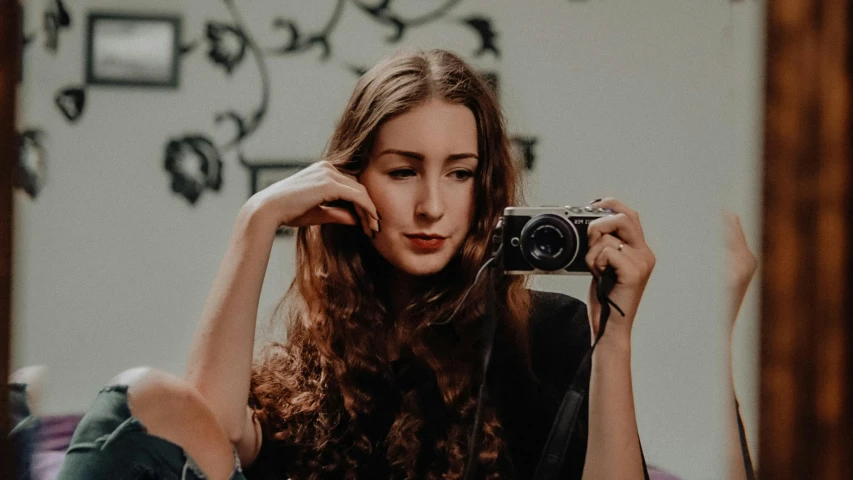 woman posing in the mirror with camera for a po