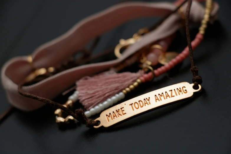 two tasselled neck pieces sitting on top of a table