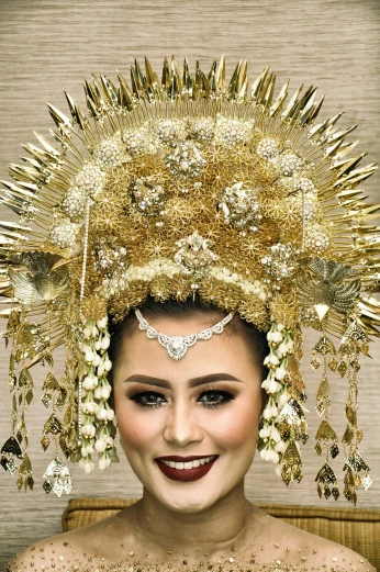 a woman wearing a tiara made of golden metal decorations