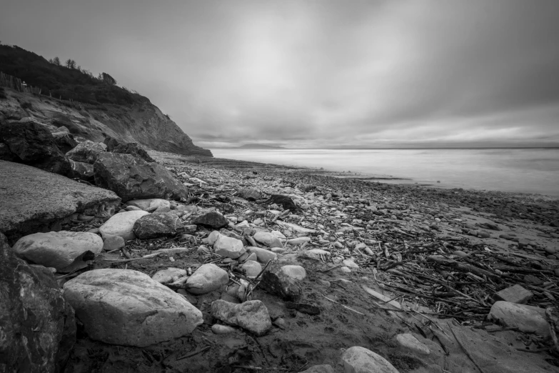 a beach with rocks and gravel on the shore