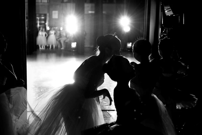 a bride and groom are dancing in the room at night