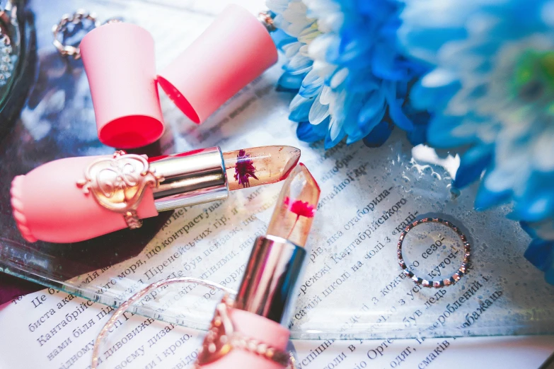 pink lipstick resting on an open page in a book