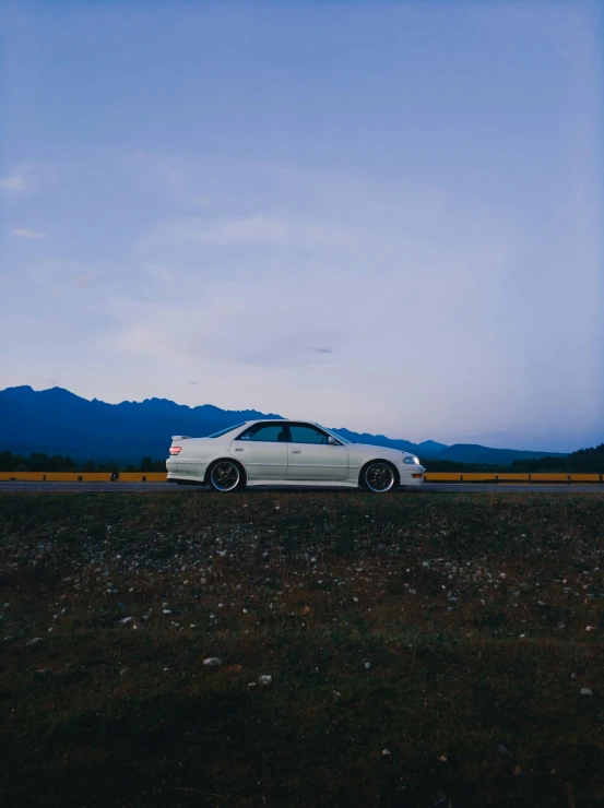 a white car that is sitting in the grass