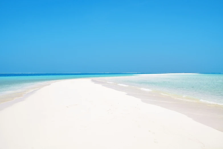 a sandy beach on an island with turquoise water