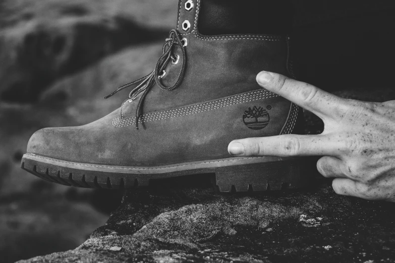 a pair of feet sitting on top of a rock