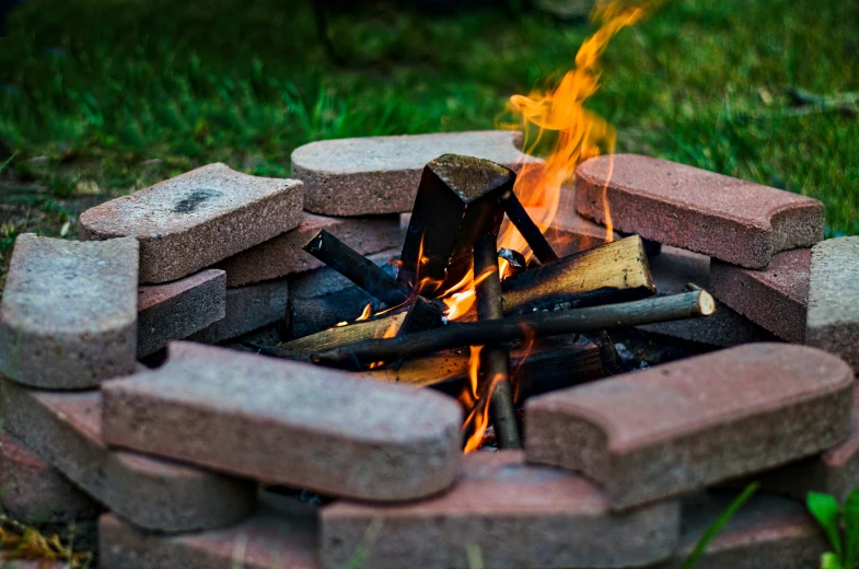 fire pit made of bricks with flames in it