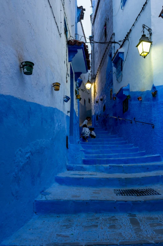 a very long and dark blue alley with steps