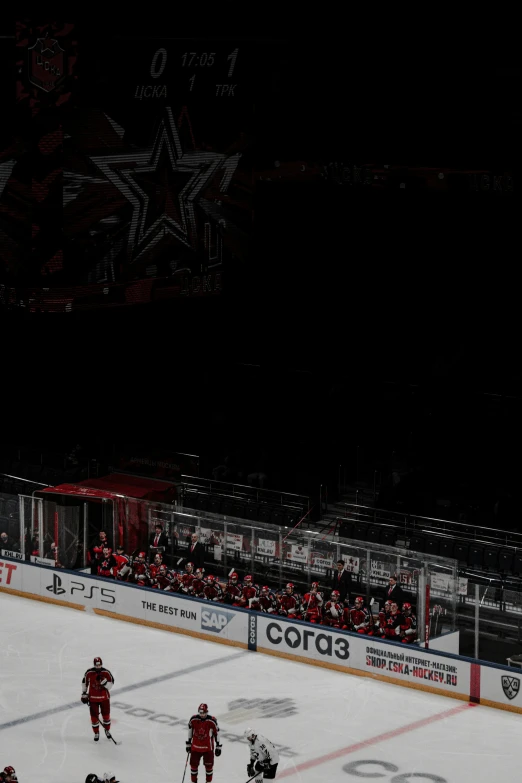 a group of men playing hockey while fans watch