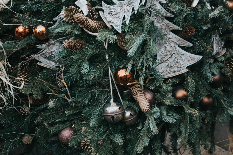 a close up view of a holiday tree with ornaments