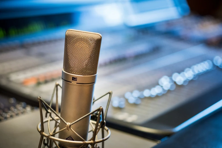 a silver microphone and mixer on a black counter