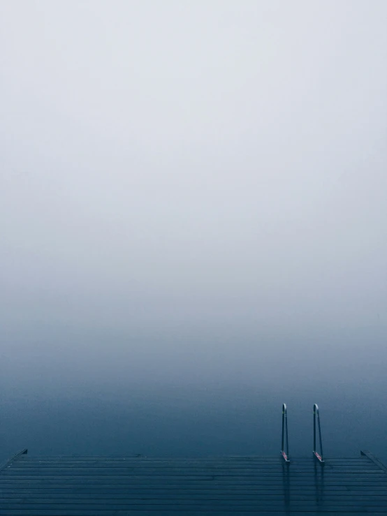 three poles are sitting next to each other on the pier