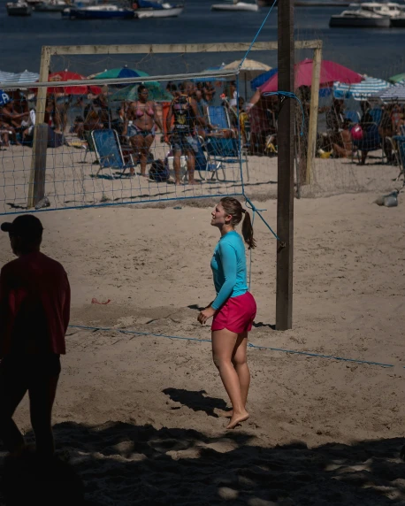 a woman playing volleyball in front of a large crowd