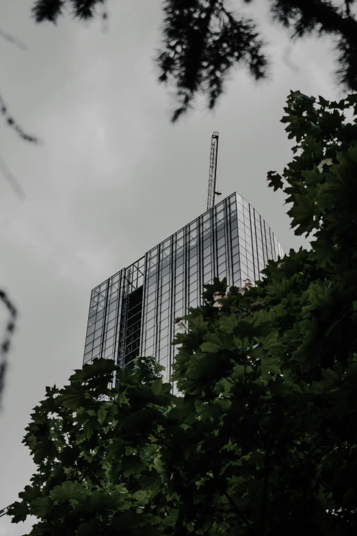 a building sits above the trees and has a tower