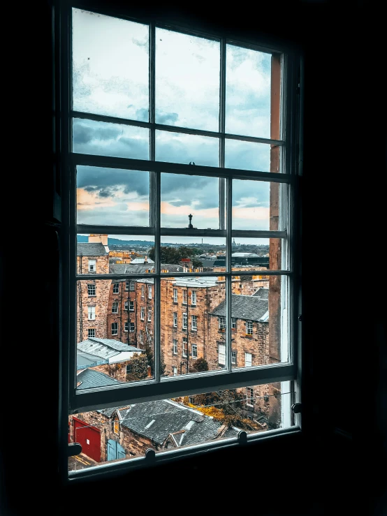 an open window is showing buildings outside